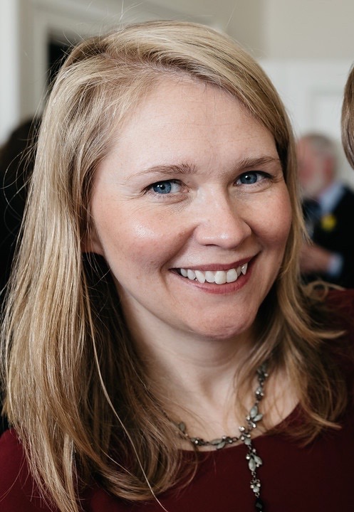 A photo of Dr. Philippa Lovatt smiling at the camera. She has blonde hair and wears a beaded necklace.