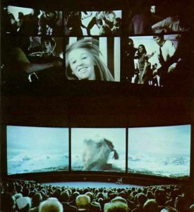 A movie theatre with multiple screens, some showing concurrent images while others show a collage of images.